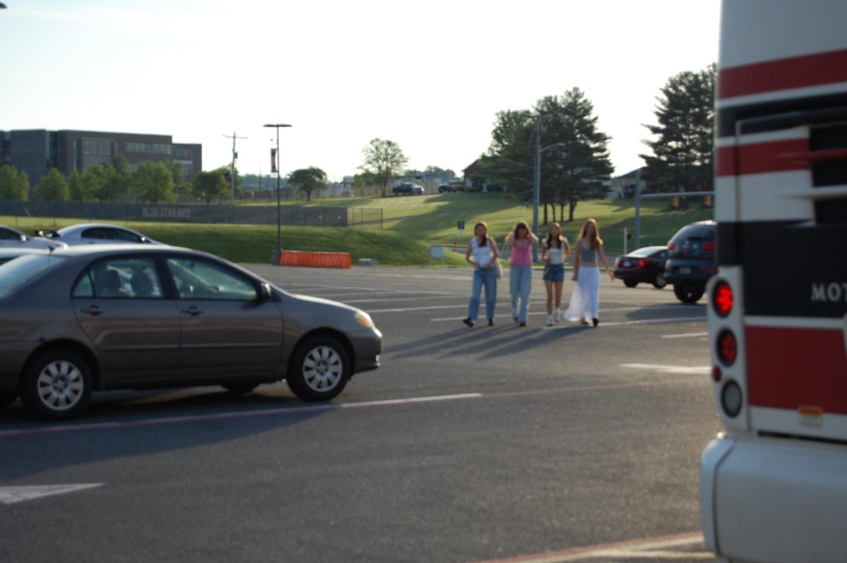 Sophomores Valentina Yoder, Kyleigh Morris, Pheonix Seidel and Avery Holt cross the parking lot.