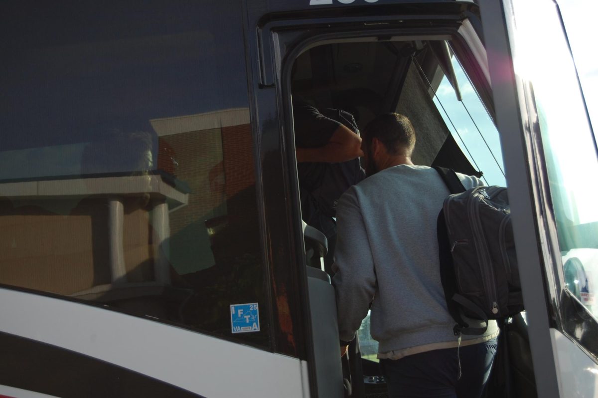 Mr. Kelly and students board bus.