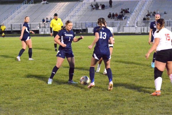 Carr and Hostetler work together to get the ball.
