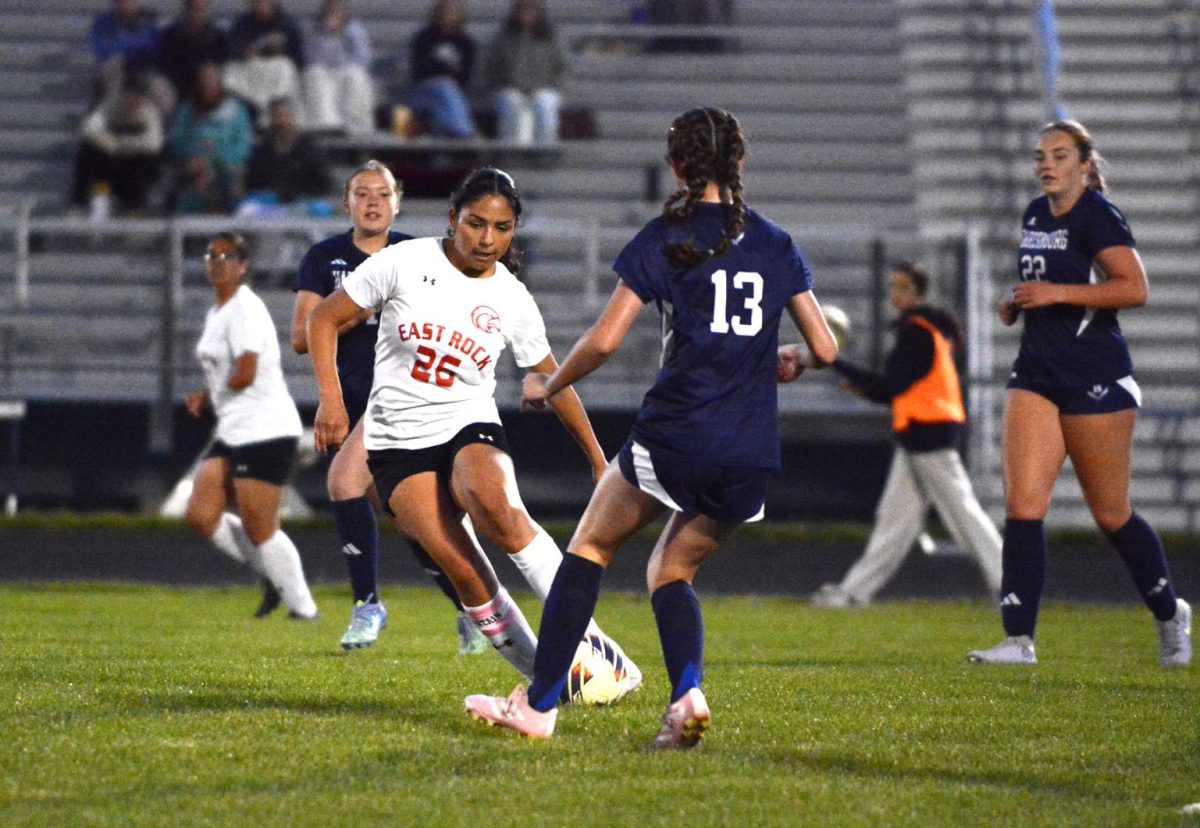 Hosteler plays defense for the ball.
