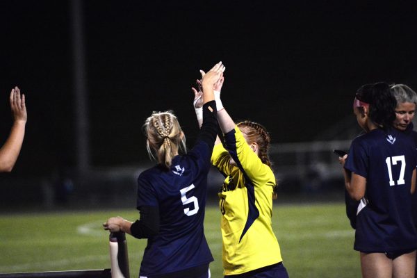 Colley high fives her teammate.