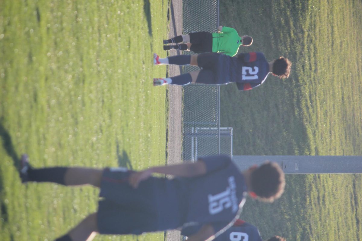 #21 Jeferson Rivera Mazariegos and #15 Kevin Velasquez Garcia stand ready in their own space, focused and alert. Though apart on the field, both players show the same calm intensity as they wait for the next move. Moments like these show the quiet focus behind the Blue Streaks’ strong team efforts.