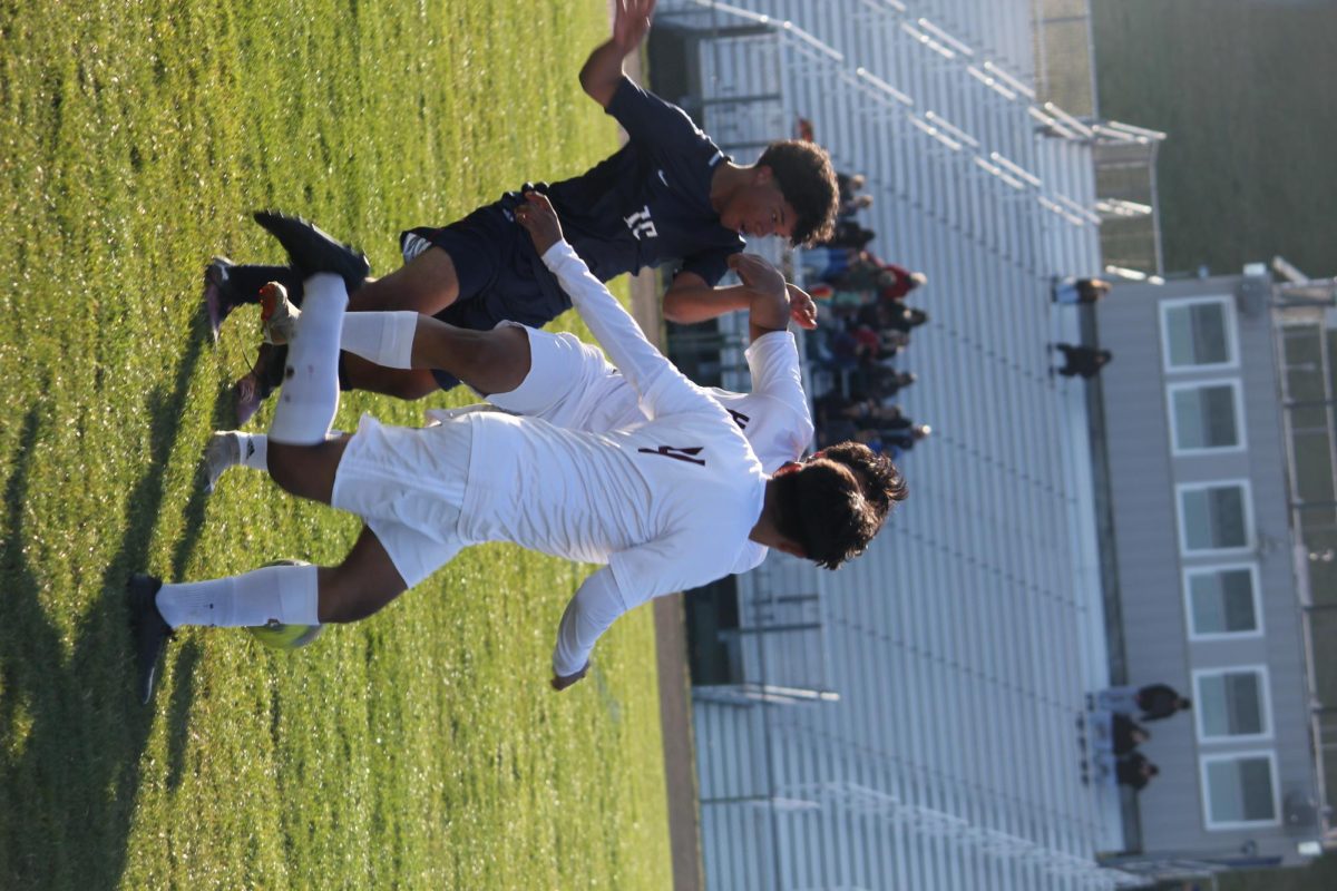 Kevin Velasquez Garcia, #15 fights for position on a corner kick. The freshman worked hard all game to give HHS chances to score. Intensity and teamwork defined the Blue Streaks' play.