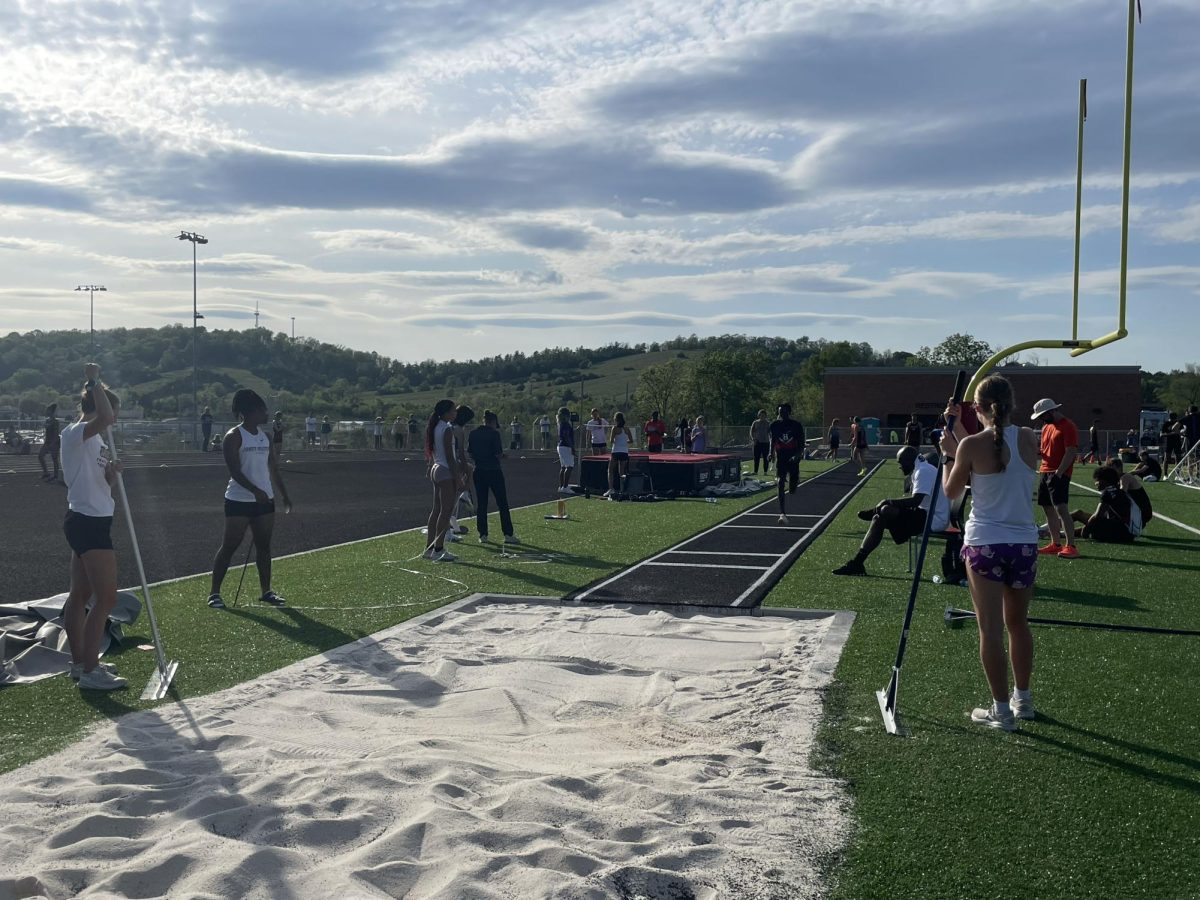 Junior Moses Iradukunda runs before jumping for long jump. 