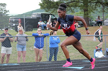 Mariah Etienne racing in the 4x1 relay.