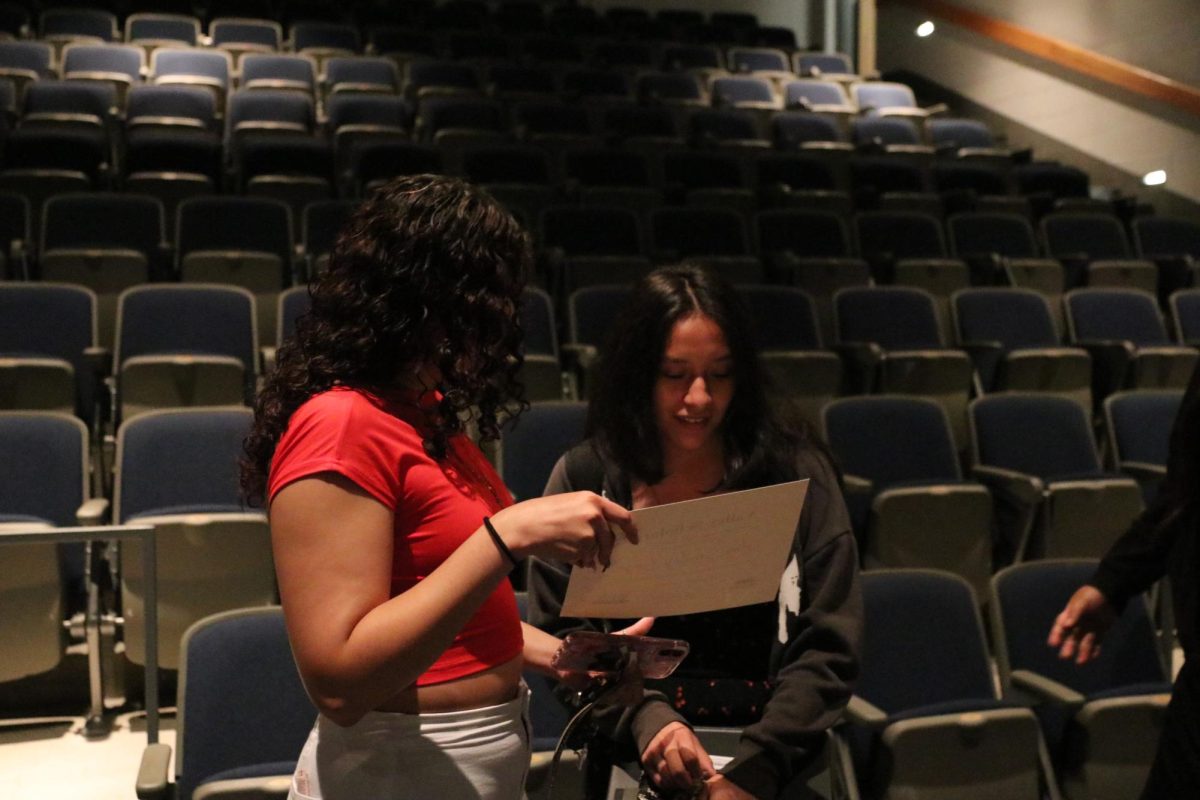 Senior Amy Sanchez sharing her accomplishments with her friends.