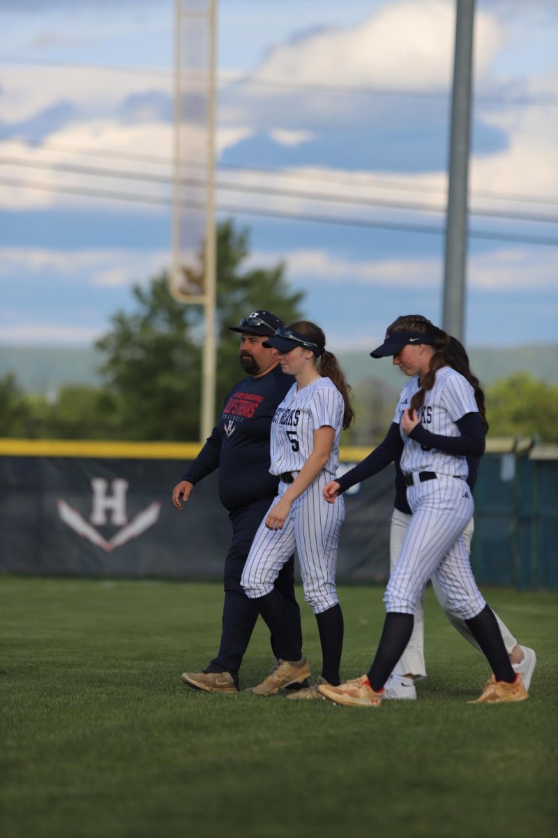 McKenna Dayton walking out with her family for senior night. "I'm really sad this is my last year playing softball with these people".
