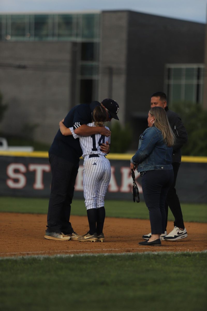 Vanessa Santiago-Ortiz hugging her coach for senior night. "I am really gonna be missing these people".