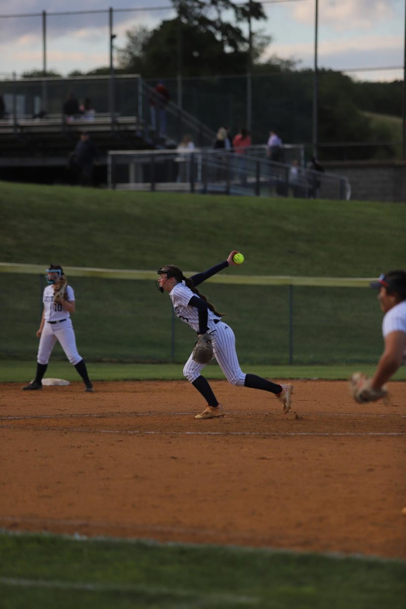 Delaney Dayton pitching to the other team. "I am super happy for my sister and can't believe she's graduating".