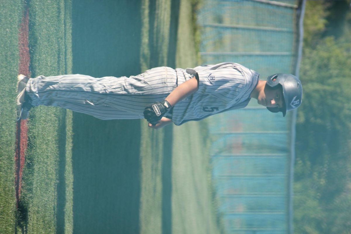 Junior Christian Torres Garcia locks eyes with the camera from the on-deck circle, calm but determined. His body is loose, but his focus is razor sharp—just pitches away from making an impact. For the Blue Streaks, every swing starts with this kind of quiet intensity.