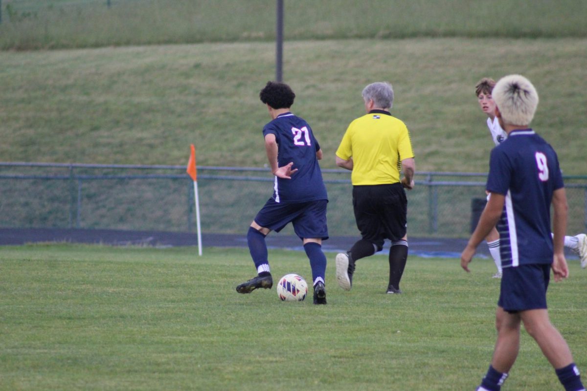 Senior Juan Chirinos rolls the ball down the field.