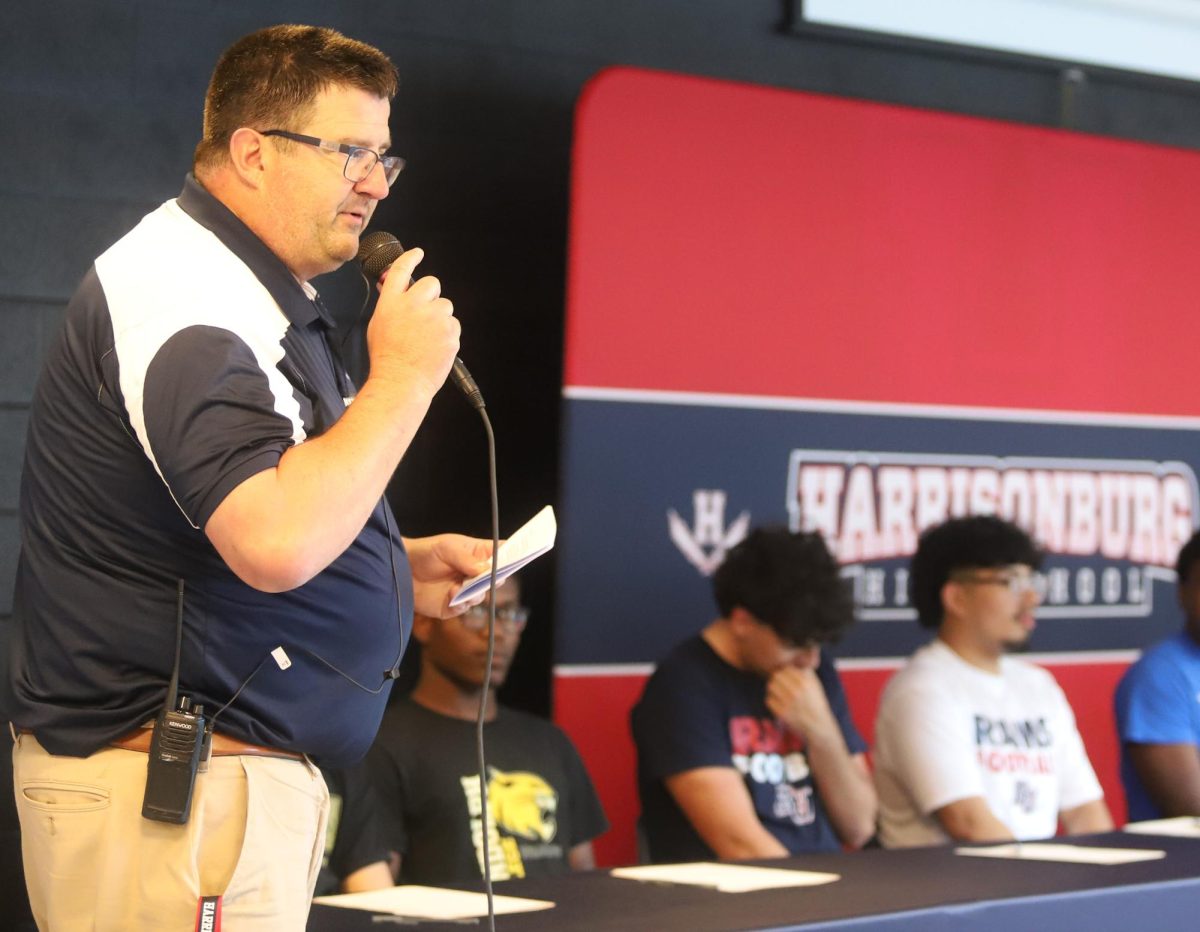 Athletic director Brandon Burley introduces the students before the signing.
