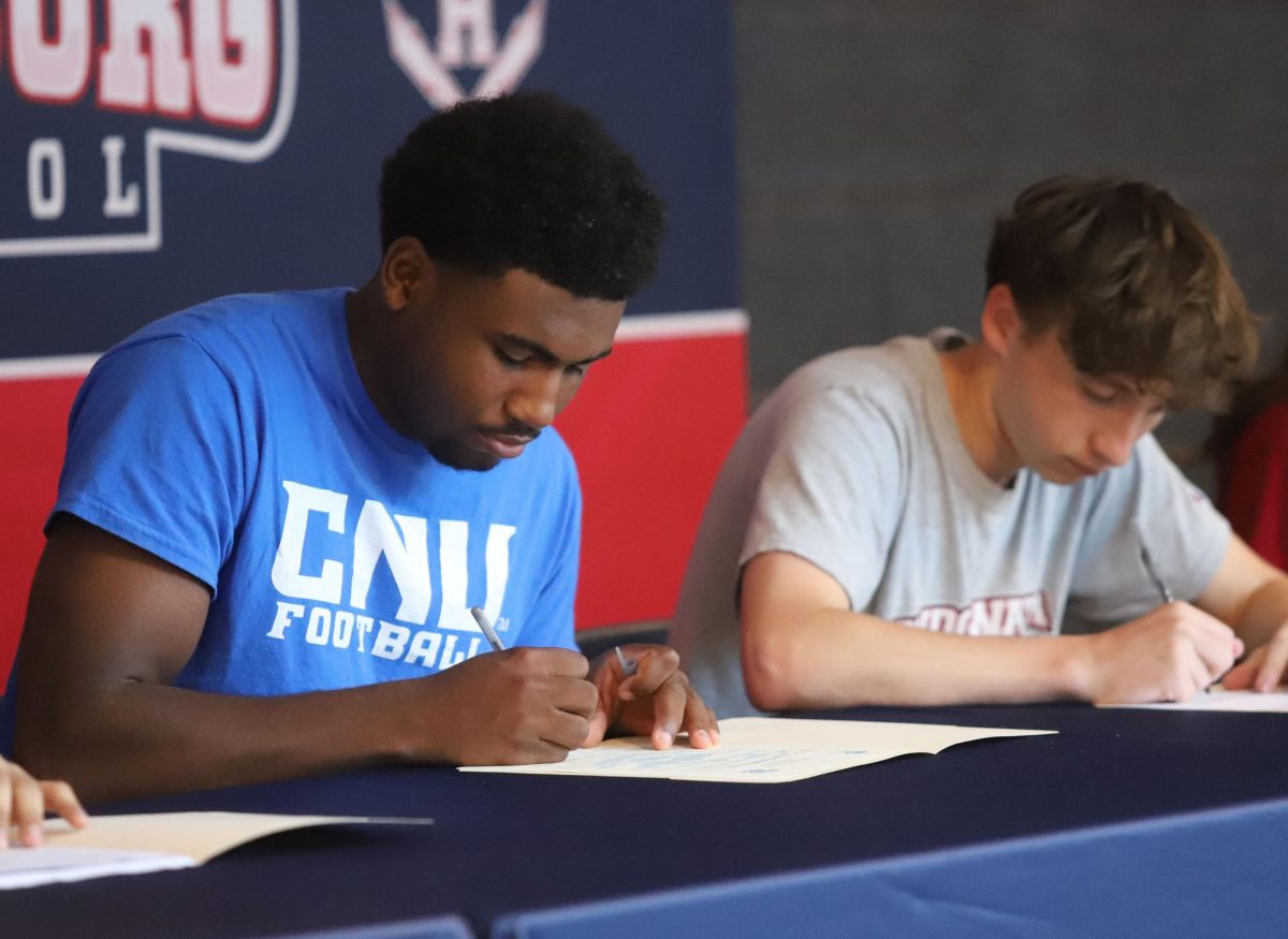 Senior Mason Smith and Kaedon Howley sign their contracts.