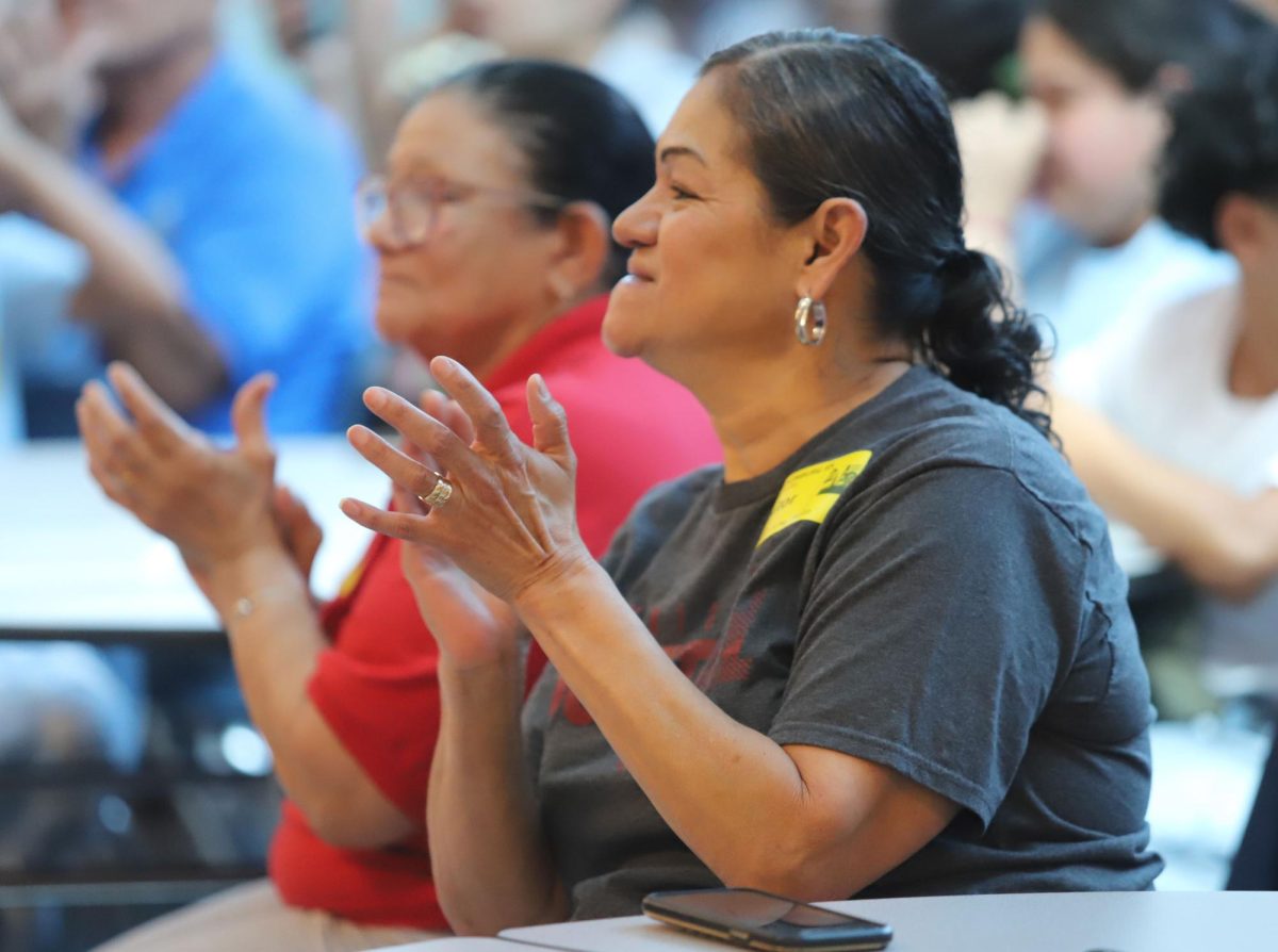 Spectators cheer as the students finish signing.