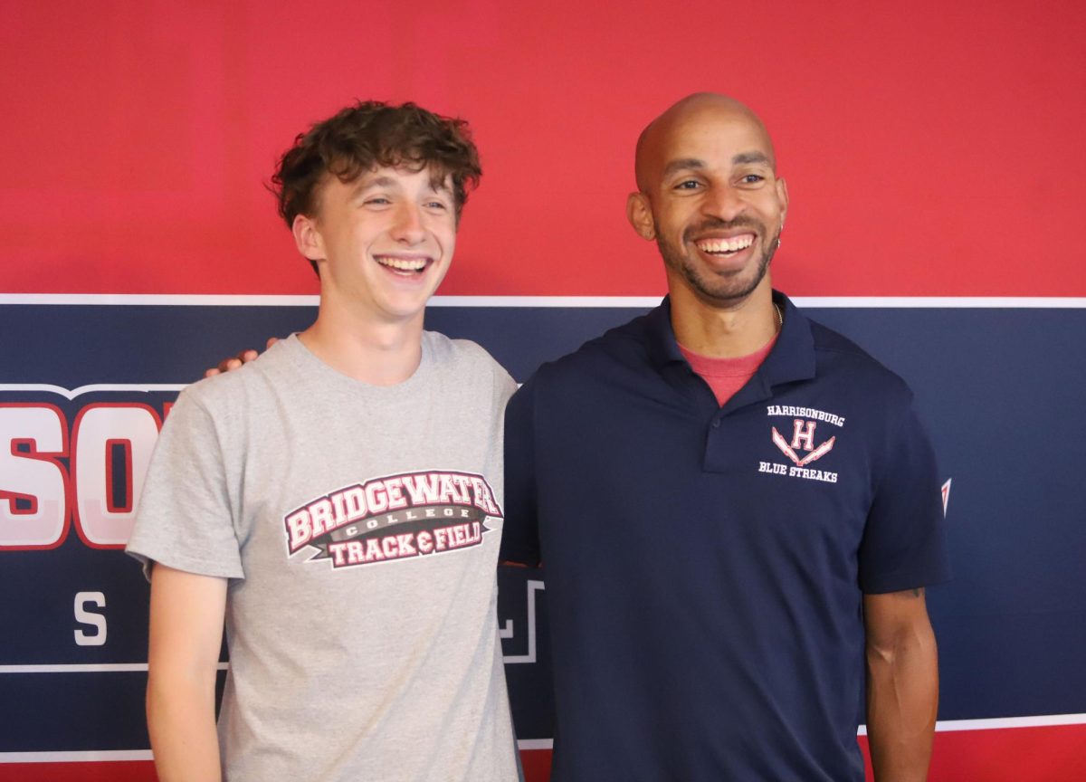 Senior Kaedon Howley gets his photo taken with track and field coach Stanley Peyton.