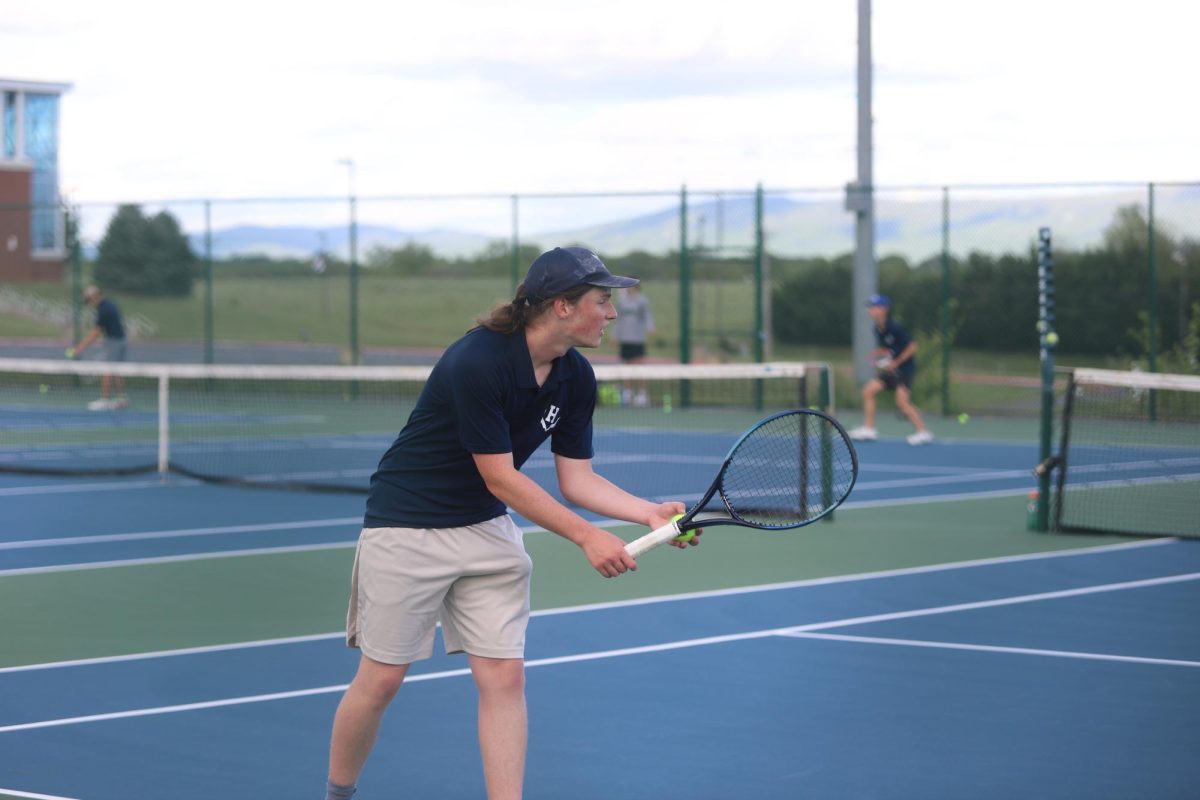 Senior Charles Bingay	serving the ball.
