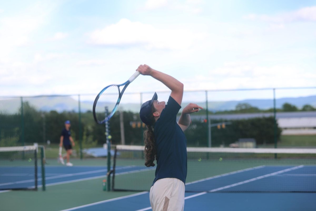 Senior Charles Bingay	hitting the ball back to his opponent.