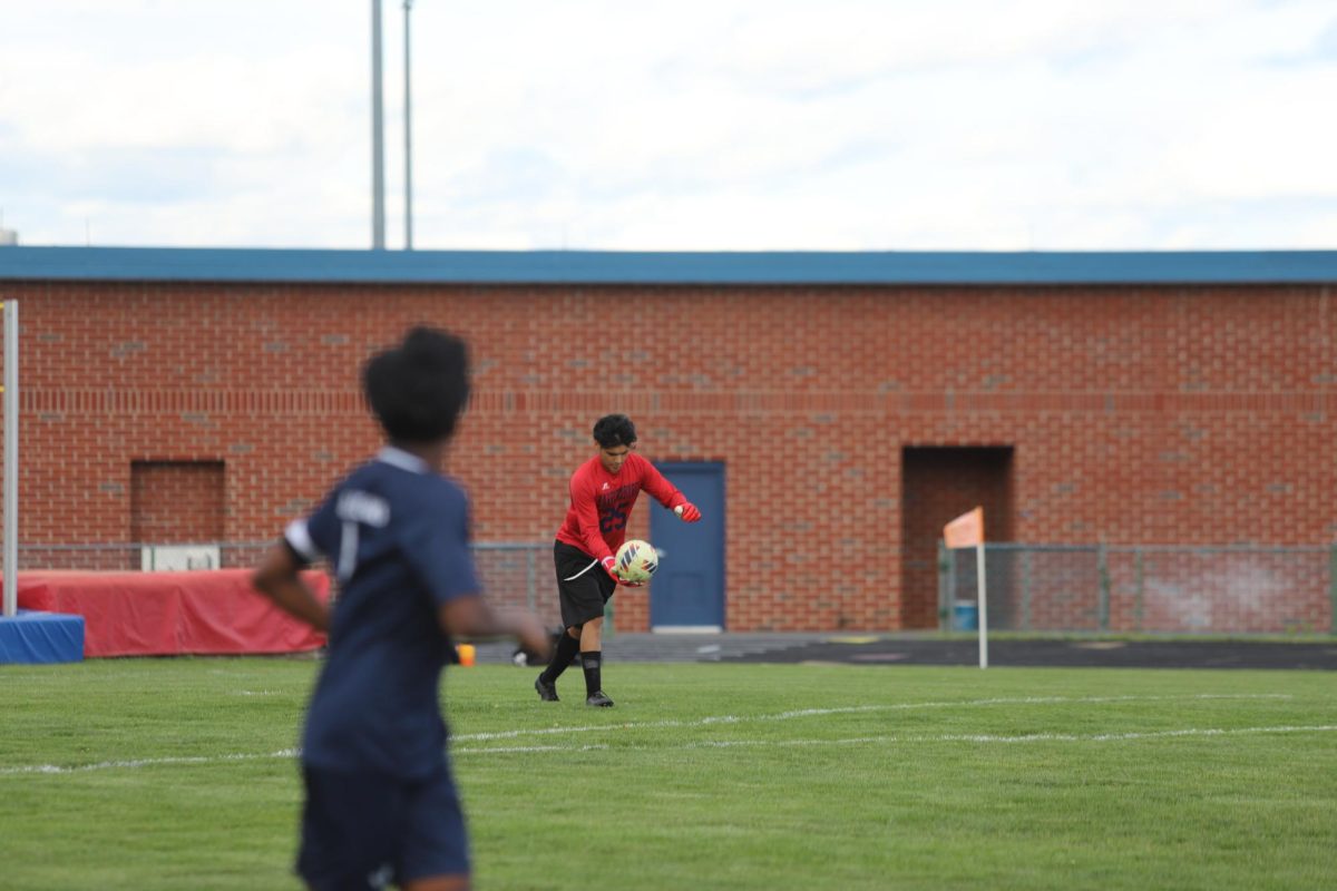 They goely kicking the ball to his team.