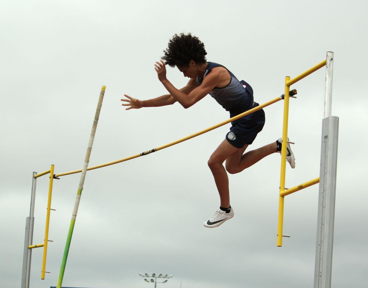 Zion Hunter falling over the bar after jumping.