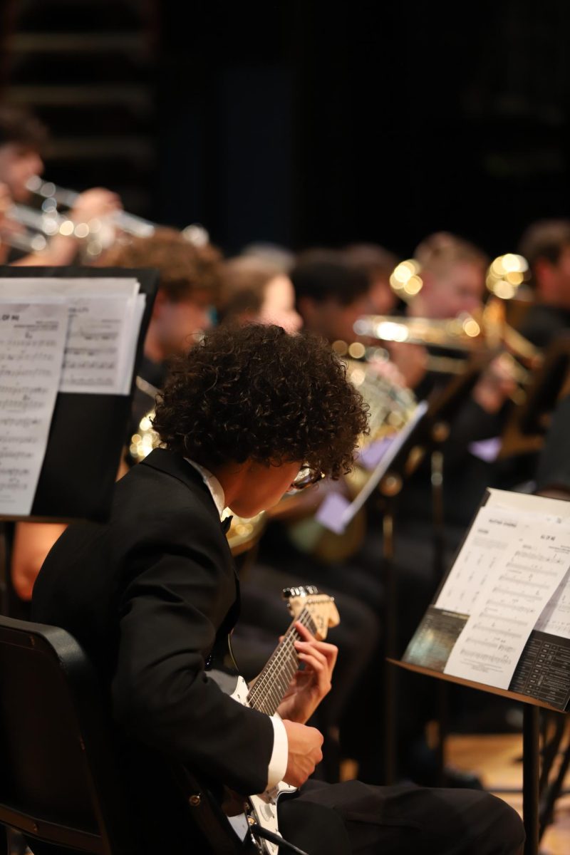 Zion Hunter playing guitar with the jazz band. "Playing the guitar I think is really cool, and the concert I think went great".