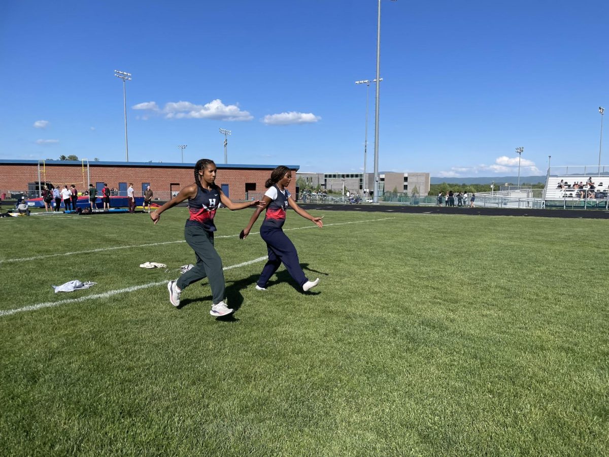 Freshman Gabrielle Jackson and Sophomore Kaylen De Los Santos Medina warm up before their events. 