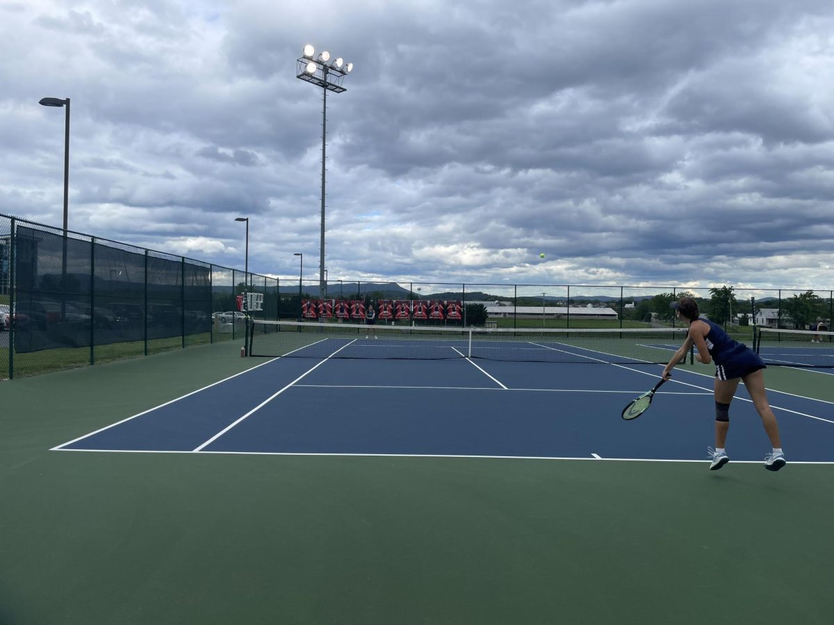 Senior Sequoia Hall hits the ball back while warming up with her teammates. 