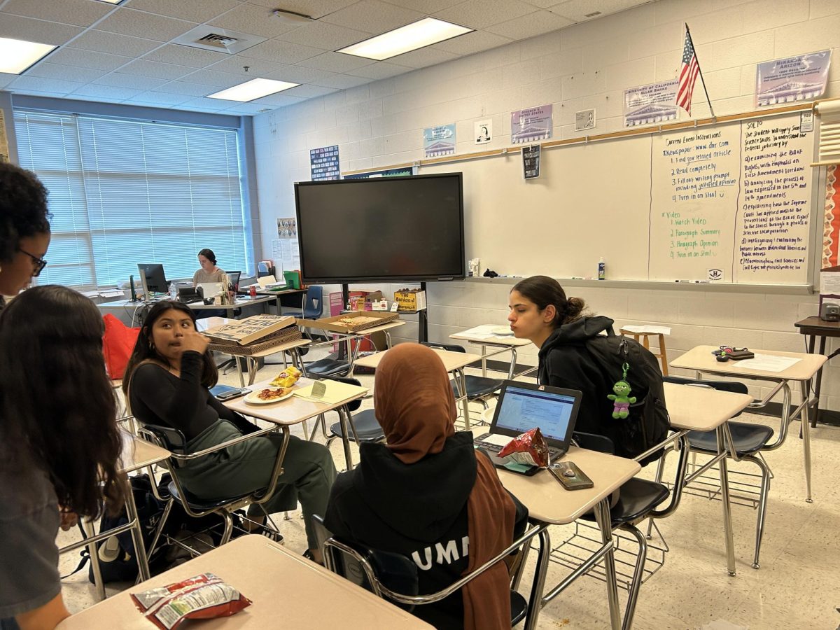 Junior Multezem Siraj talks with other students.