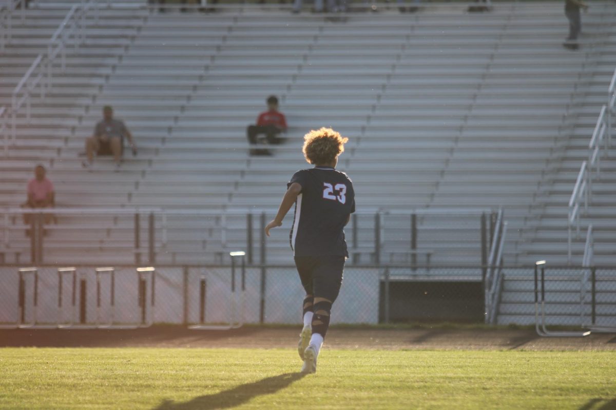 Junior Kaiden Velasquez running on the field.