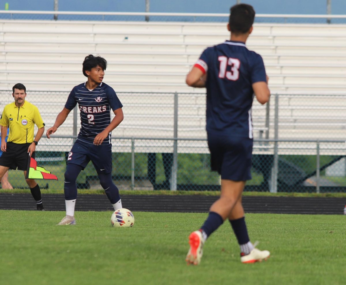 Freshman Andy Mendoza Flores kicking the ball to his teammates