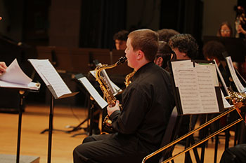 Freshman Mateo Starling is playing the saxophone.