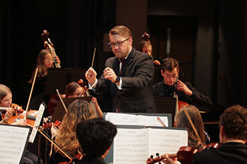 Mr. Upton is guiding the band through a beautiful performance.