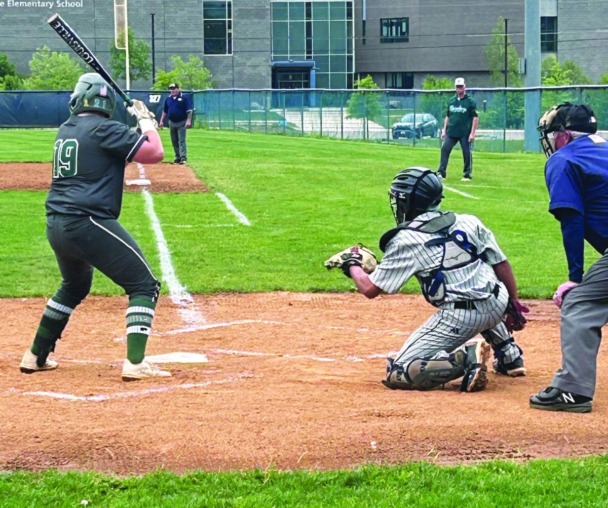 Junior Diego Pichardo Encarnacion catches the pitch as it comes in.