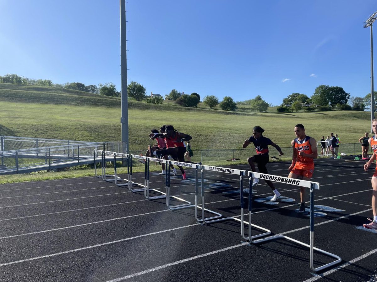 Senior Kalaib Gebrehaimanot runs the 100 meter with ten hurdles in front of him. 