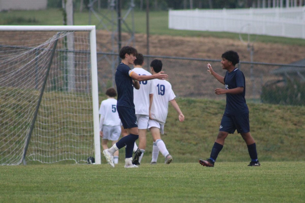 Freshman Kevin Velasquez and Eighth Grader Leo Kurtz celebrate after a goal.