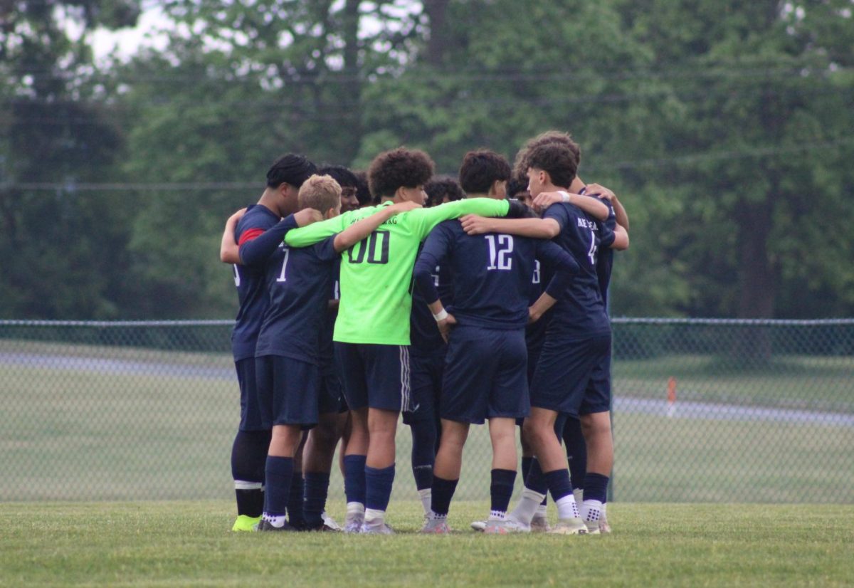 JV Boys soccer team huddles up before the game. 