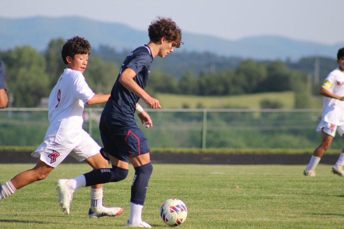 Eighth Grader Leo Kurtz runs down the field possessing the ball.