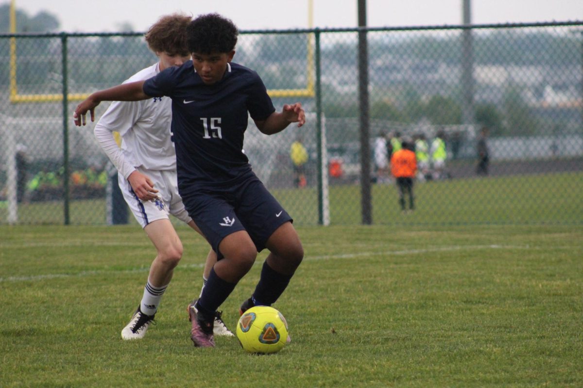 Freshman Kevin Velasquez goes against opponent.