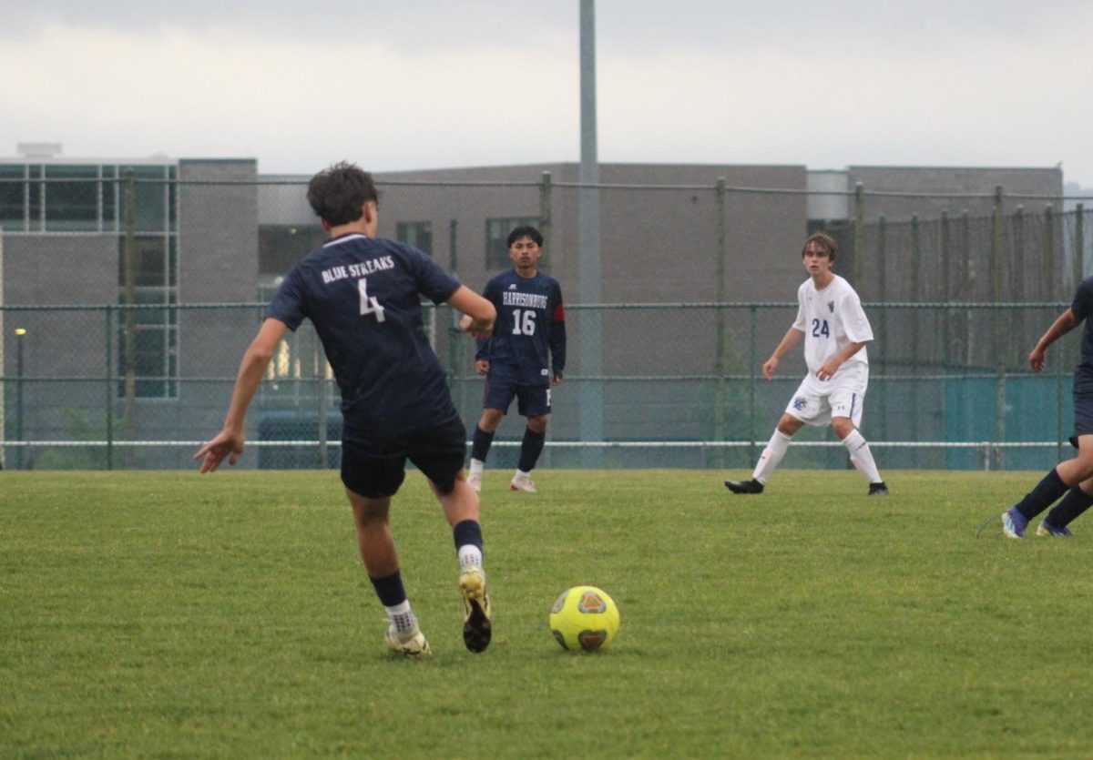 Freshman Silas Long receives and kicks the ball.