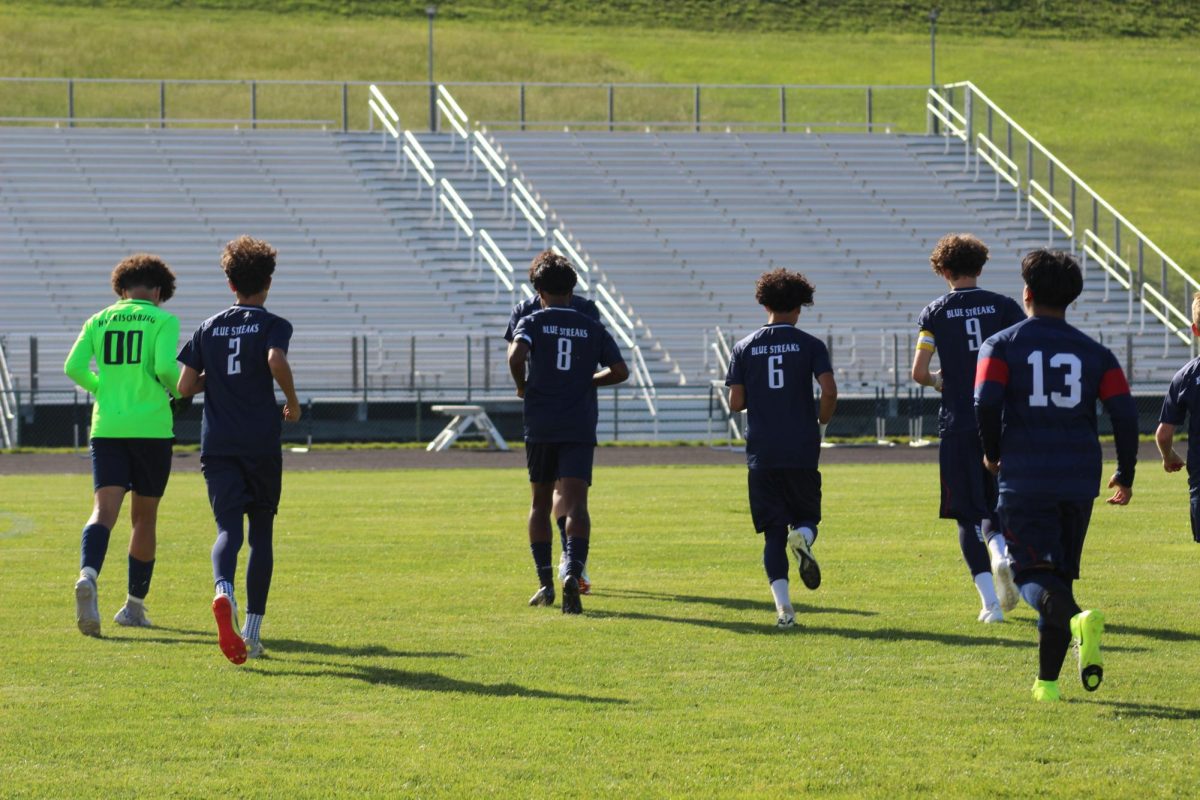 JV team jog to position to start the game.