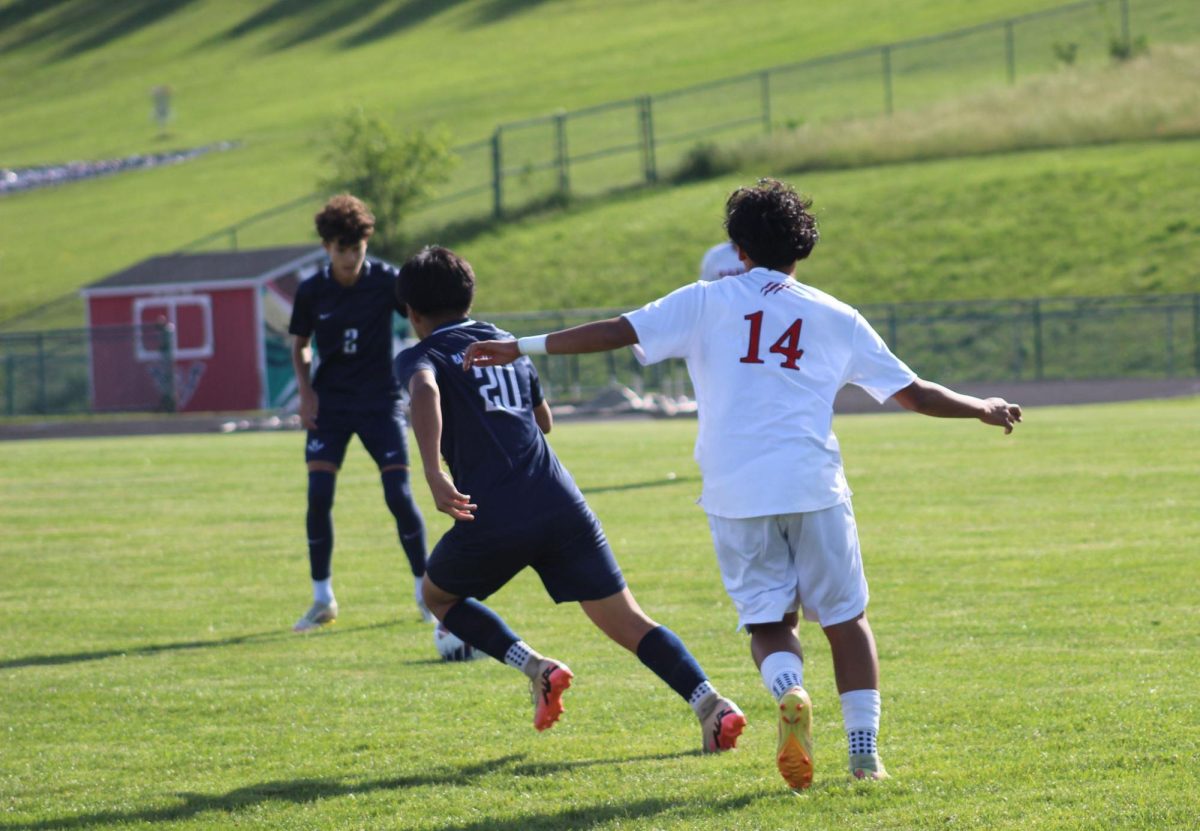 Eighth grader Joel Metzler receives the ball after Sophomore Josue Sontay kicks it.