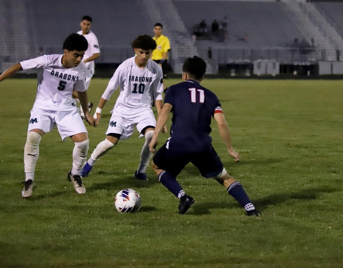 Senior Izaack Gonzalez trying to get the ball around his opponents.