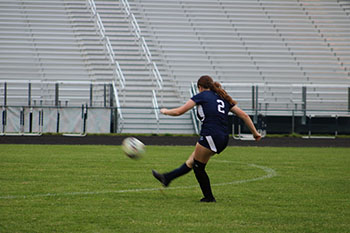 Junior Grace Tysinger takes a powerful kick to the ball to score a point.