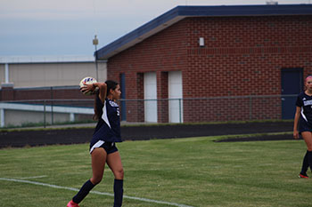 Senior Leeanne Lara Irias is throwing the ball to her teammate.