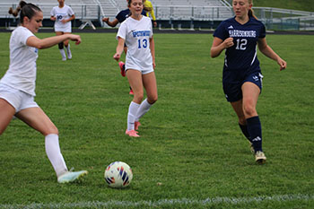 Sophomore Katherine Schwartz is running towards the ball to steal it.