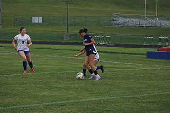 Freshman Yoany Cardona is being double teamed while trying to shoot a goal.