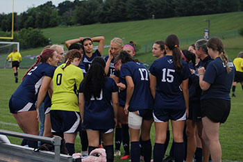The girls group up to make a plan to win the game.
