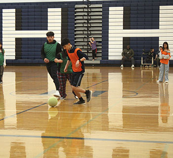 Two opponents fighting to get ahold of the ball