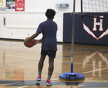 Fresh man Riyon Loku Umagiliyage about to make a shot through the hoop