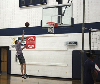 Freshman Samuel Maust jumps high off the ground and goes in for a perfect shot