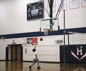 Freshman Bahaa Dawood aims to shoot a basketball 